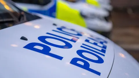 Generic image - close up on the bonnet of a Police Scotland car with other cars blurry in the background