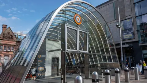Getty Images The entrance to St Enoch subway station - a domed glass structure with metal bollards outside