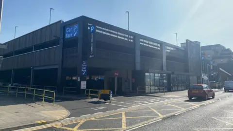 John Wimperis An external view of the car park, a multi-storey structure with a concrete exterior