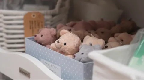 box full of soft teddy bears, pink and blue in colour