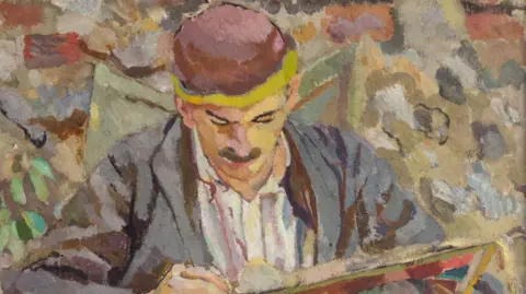 THE CHARLESTON TRUST A portrait by Duncan Grant of John Maynard Keynes writing in a notebook, while wearing a light grey suit, white shirt and a red hat.