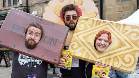 Richard Eyers Photography Two men and women wearing large collars in the shape of popular biscuit brands