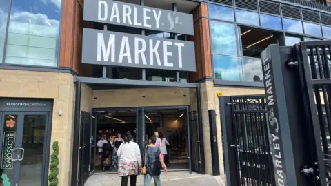 People walking in and out of Darley Street Market.