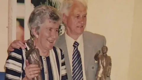 An archive photo of Sir Bobby Robson with his hand on Pat Godbold's shoulder