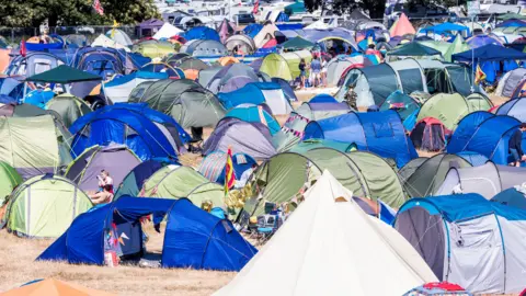 Getty Images Tents in a field. 