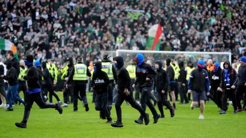 PA Media Pitch invasion after Celtic win on penalties after the Scottish Gas Men's Scottish Cup quarter-final match at Ibrox Stadium, Glasgow. Picture date: Sunday March 8, 2026. 