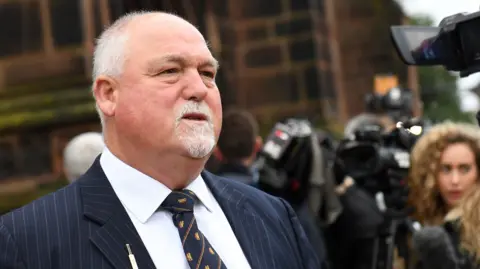 Mike Gatting, wearing a shirt and tie