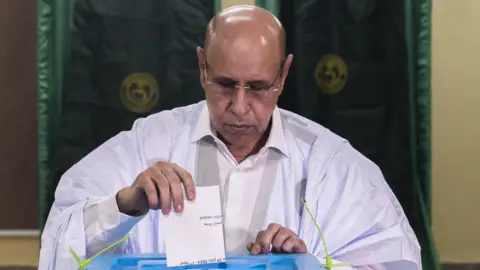 Incumbent Mauritanian President Mohamed Ould Ghazouani casts his ballot at a polling station in Nouakchott on June 29, 2024.