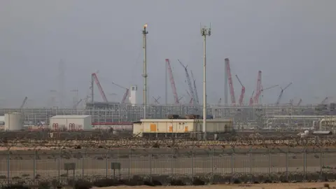 Ras Laffan LNG refinery, with towers and cranes visible in the background.