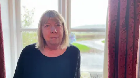 BBC The roads around Janet Hewlett's home are currently flooded