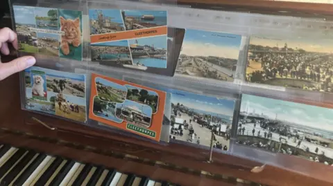 Lara King / BBC Collection of old postcards on a piano