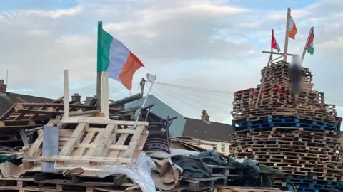 Bonfire in rathcoole with Republic of Ireland flag placed on top