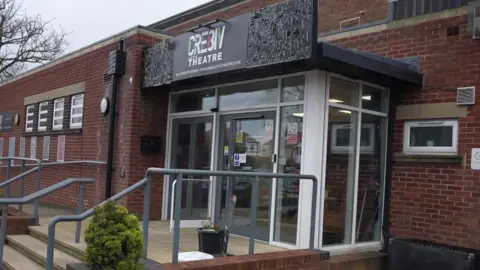 Exterior of the theatre school a low rise brick building.