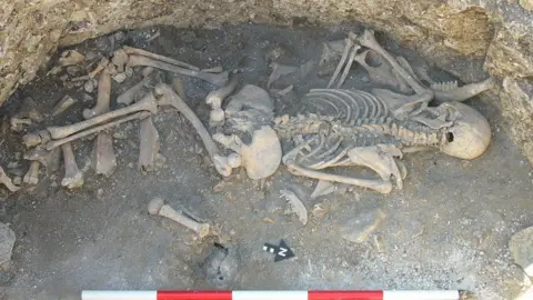 Bournemouth University A human skeleton in the bottom of an archaeological pit