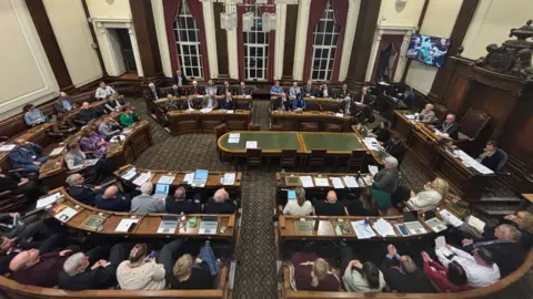 A packed extraordinary general meeting at Wallasey Town Hall.