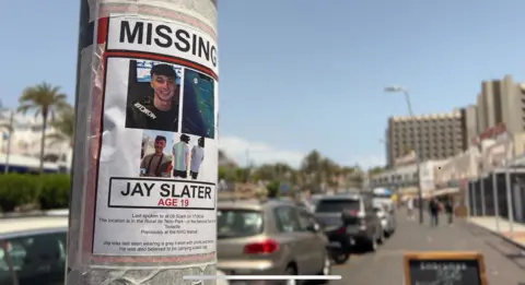 A missing Jay Slater poster is taped to a lamp-post in Tenerife