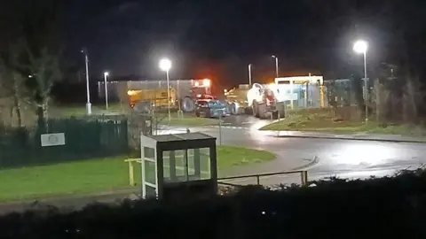 Michaela Staddon Two yellow tankers are next to the pumping station at HMP Millsike. The photograph is taken in the early hours of the morning. 