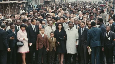 Getty Images Crowds after the assassination of Martin Luther King in Memphis. Jesse Jackson is standing behind King's wife, Coretta. Harry Belafonte is also visible in the picture