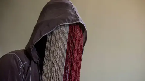 AFP Anas Aremeyaw Anas wearing a beaded mask