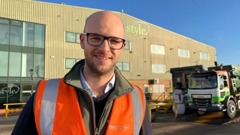 Martin Heathcote, CEO of Countrystyle Recycling, stands at the company HQ with a tipper truck in the background