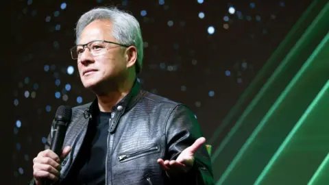 Getty Images Nvidia CEO Jensen Huang holds a microphone as he speaks during a tech conference in Taiwan
