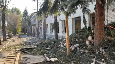 Imogen Anderson / BBC Daylight: an bare  thoroughfare  successful  Pokrovsk filled with piles of rubble and breached  branches from damaged buildings and trees. Windows person  nary  glass.