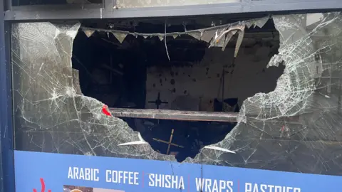 PA Media Image shows Bash Cafe with a hole in the window 