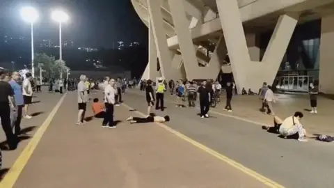 Reuters Wounded people lie on the ground after a suspected hit-and-run attack outside a sports centre, in Zhuhai