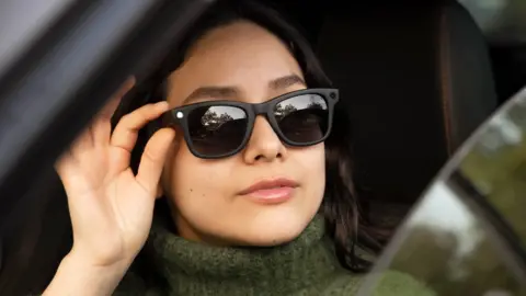 Getty Images Woman driving a modern car while wearing smart AI sunglasses