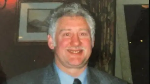 South Yorkshire Police James Joseph Corrigan wears suit and tie, has gray hair and moustache 