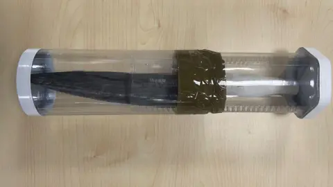 Crown Office A black knife with a white handle in clear plastic box