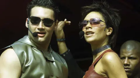 PA Media Victoria Beckham and Dane Bowers perform at the Radio 1 Roadshow in 2000