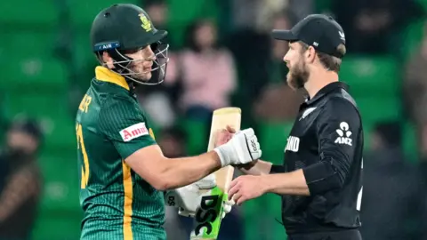 South Africa's David Miller and New Zealand's Kane Williamson shake hands in a Champions Trophy match earlier in 2025