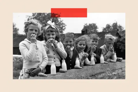 Getty Images A group of children drink milk in a black-and-white image