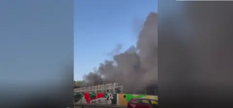 plumes of smoke from bus depot