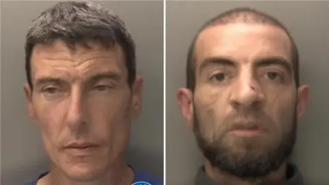 Police mug shots of the two men. The man on the left has brown/grey hair and is wearing a blue T-shirt. He is looking slightly down to the left of the image. On the right, a man with short brown hair and a beard looks directly at the camera. He has a broad nose with a cut on it. He is wearing a grey zip-up top.