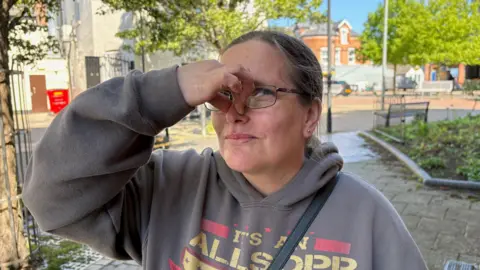 BBC Woman pinching nose