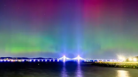 The lights were visible over landmarks in New York City on Thursday