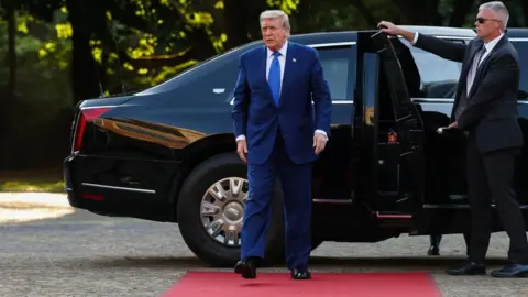 Trump on the red carpet after exiting a car in the Netherlands