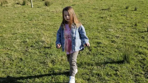 Supplied Sienna Dunion walking in a field