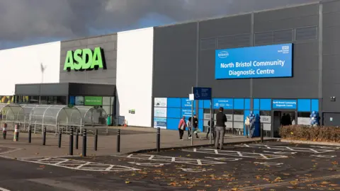 A computer generated image of the North Bristol Community Diagnostic Centre, which is next to the Asda supermarket in Cribbs Causeway. The illustration shows people outside of the clinic.