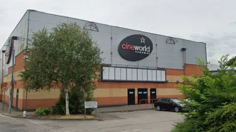 Cineworld in Bedford is a blocky building, the bottom half is made of bricks and the top half has grey cladding with large black Cineworld signs.