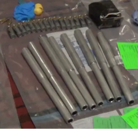 COPFS Metal poles and bullet cartridges laid out on a table with blue examination gloves