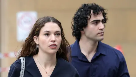 Reuters A young woman with long dark hair and earrings and a man with curly black hair 