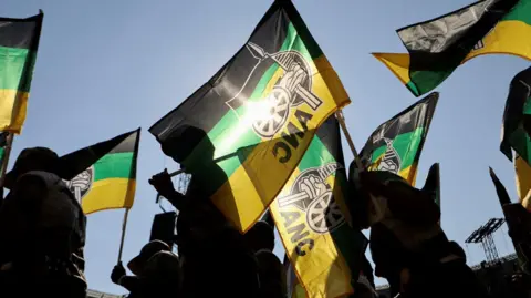 Reuters ANC supporters carry party flags in Johannesburg, South Africa. Photo: May 2024