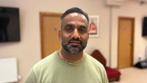 Shyam Govinda standing in the yoga-centre in Crawley where the Hari Krishna community is based. 