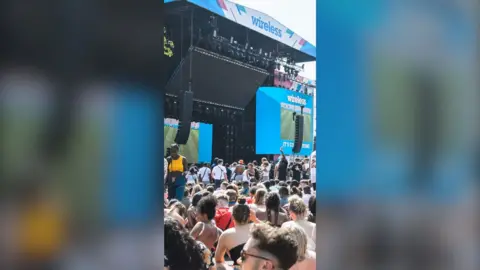 Crowds of people stand in front of a stage at a previous Wireless Festival.