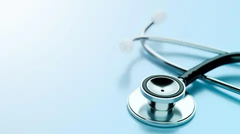 A silver stethoscope on a blue background.