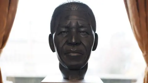A proposed statue of Nelson Mandela. It is a sculpture of his head.