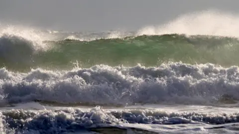 BBC Weather Watcher/Jane Lewarne A series of waves are seen rolling into the shore.